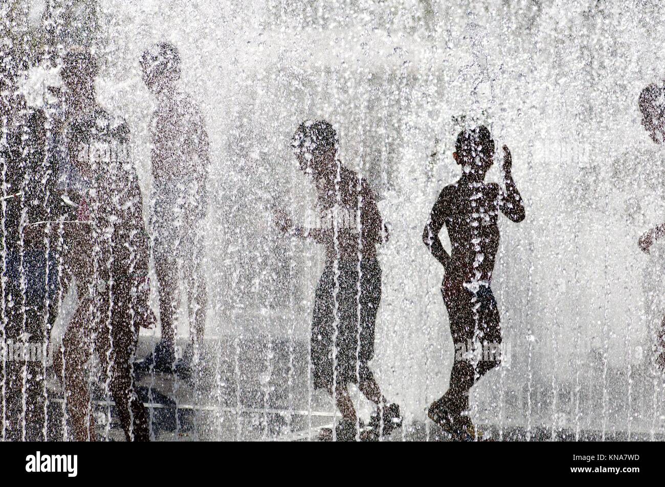 silhouette of a group of children playing in a water fountain Stock ...