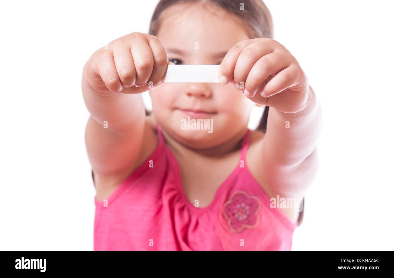 Young girl holding a fortune cookie paper with the empty message ready to fill. Stock Photo