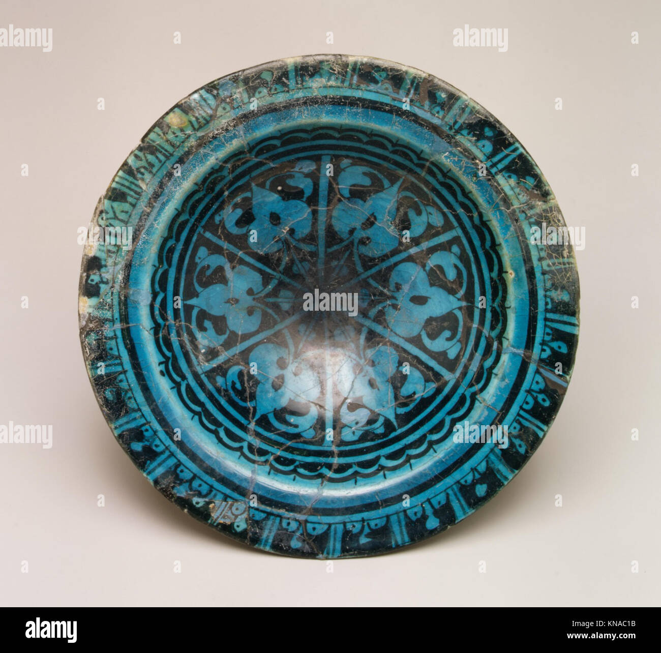 An Islamic bowl featuring geometric patterns and detailed craftsmanship ...