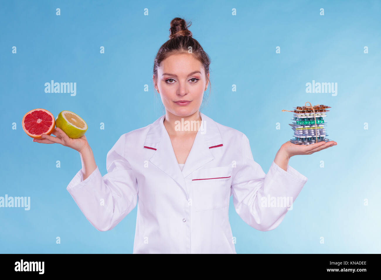 Dietitian nutritionist woman holding diet weight loss tablets pills and