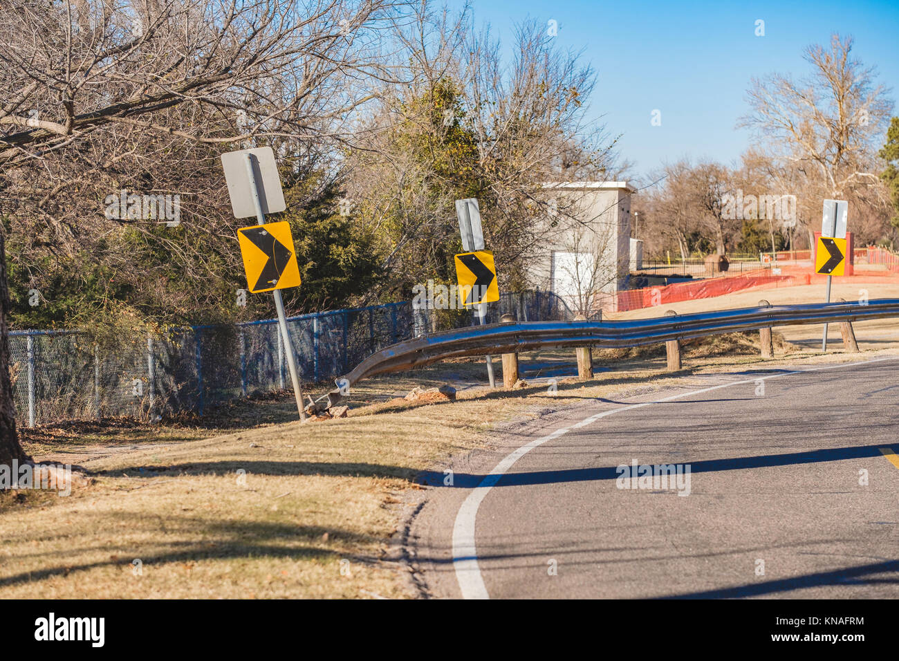 Arrow signs or warning signs alerting of a curve in the road in Oklahoma, USA, North America. Stock Photo