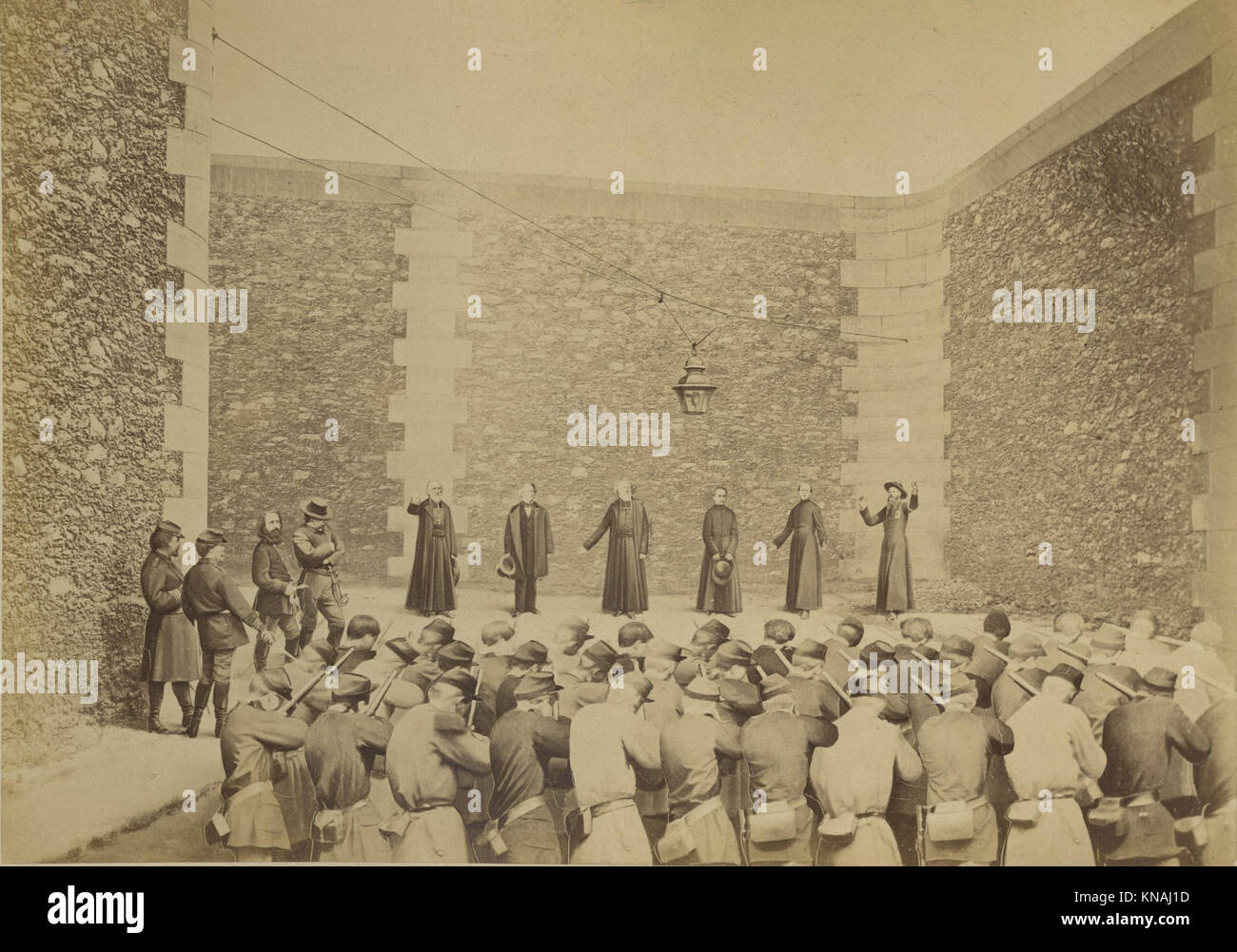 This image captures the execution of hostages at the La Roquette prison on May 24, 1871, during the violent events of the Paris Commune. It provides a poignant representation of the historical and tragic moments of the time. Stock Photo