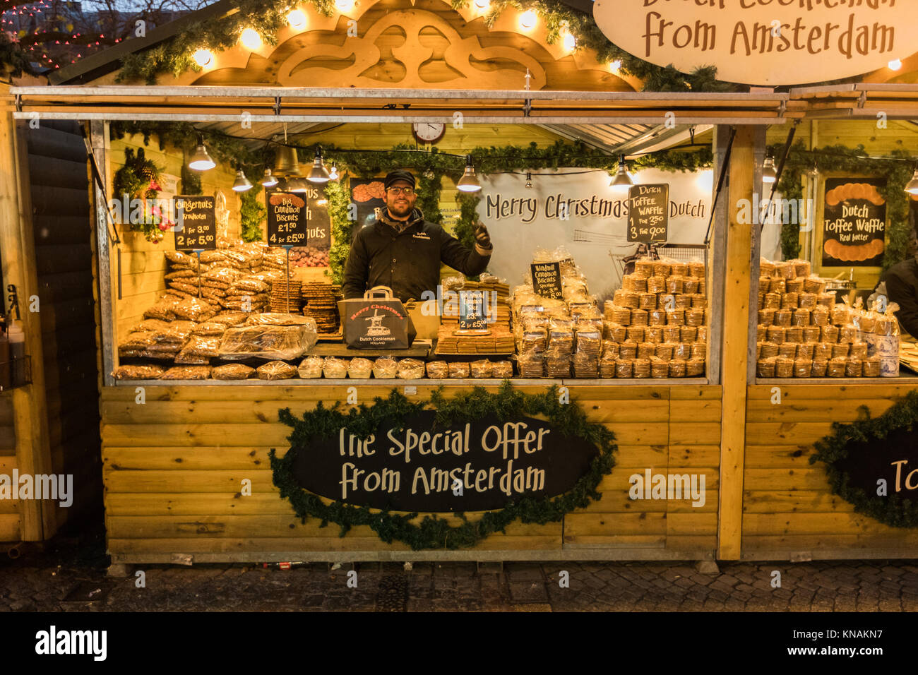 Market stall traders serve food and drink to customers at Manchester