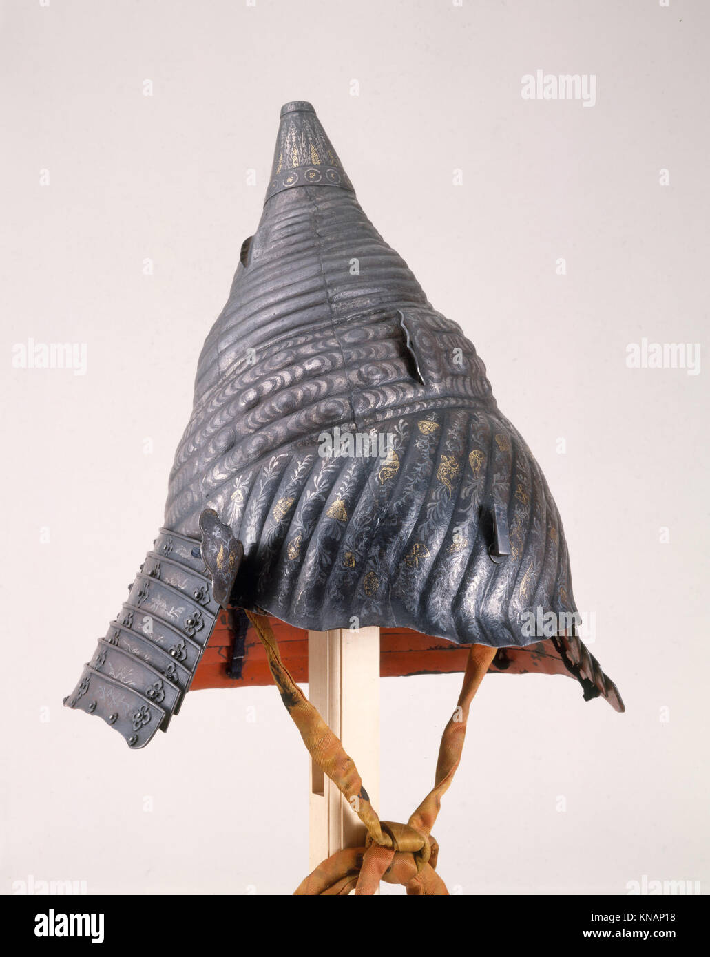 This helmet, shaped like a sea conch, is a unique piece of armor. Its ...