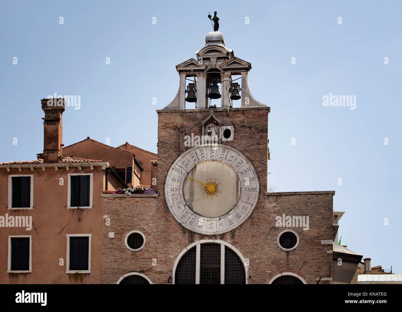 View of San Giacomo di Rialto Church with blue sky background in Venice / Italy. Catholic gothic building dating to circa 1071 CE, with a large, iconi Stock Photo