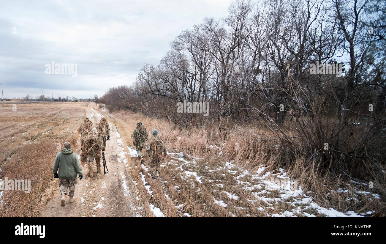 Defenders from the 791st Missile Security Forces Squadron search for hiding locations during joint-unit training at Minot Air Force Base, N.D., Nov. 22, 2017. During the joint-unit training, 791 MSFS defenders evaded capture by 5th Security Forces Squadron K9s and their handlers. (U.S. Air Force Stock Photo