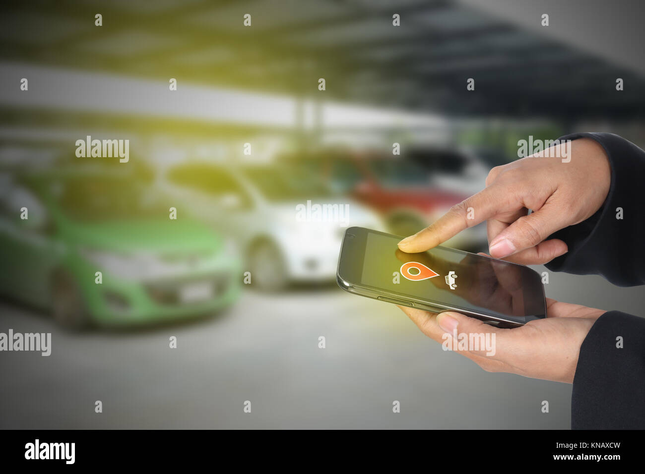 "car finder" female hand useing mobile phone against car park