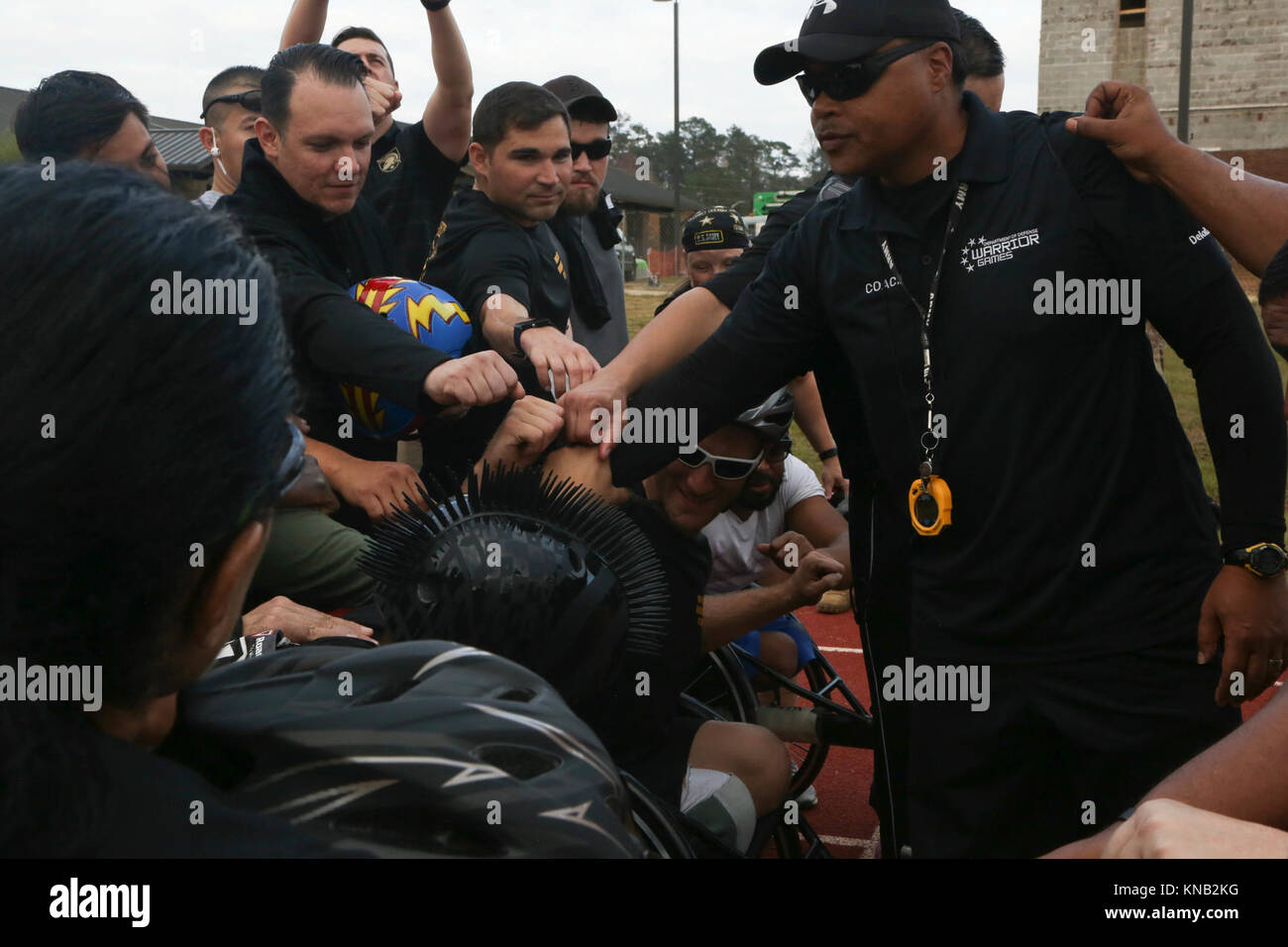 U.S. Army athletes huddle together after completing track events for ...