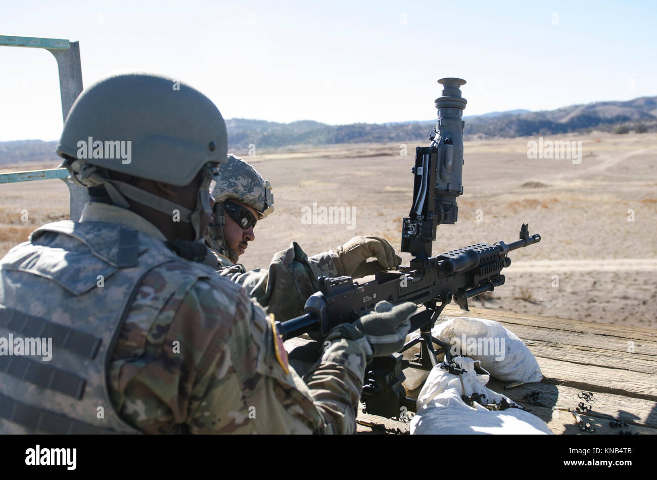 U.S. Army Reserve Pfc. Ricardo Ramirez loads a round into an M240B ...