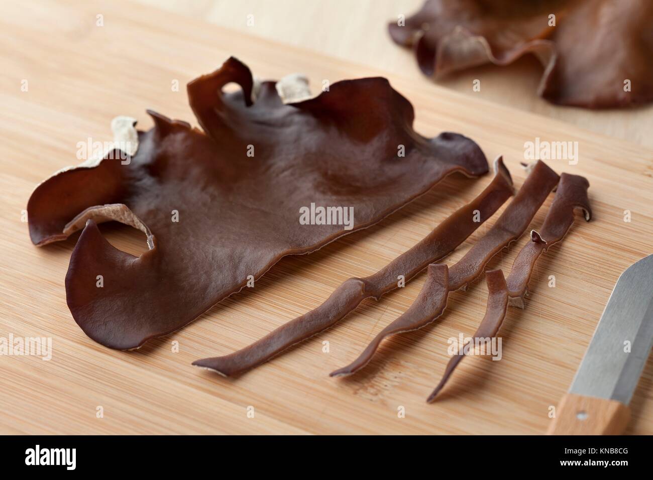 Jelly ear mushroom cut into slices on a cuttingboard. Stock Photo