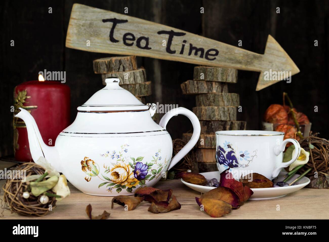 Cup of Tea and Teapot On Wooden Table. Arrow Sign With Text, Tea Time Written On It in The Background. Stock Photo