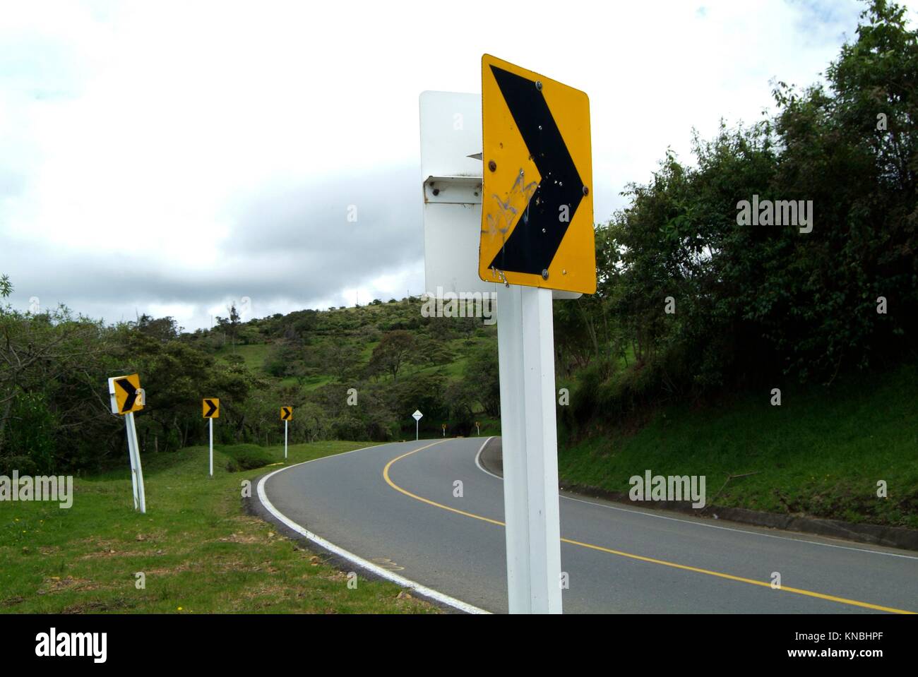A road sign for a curve in the road near Silvia, near Popayan, Colombia, South America. Stock Photo