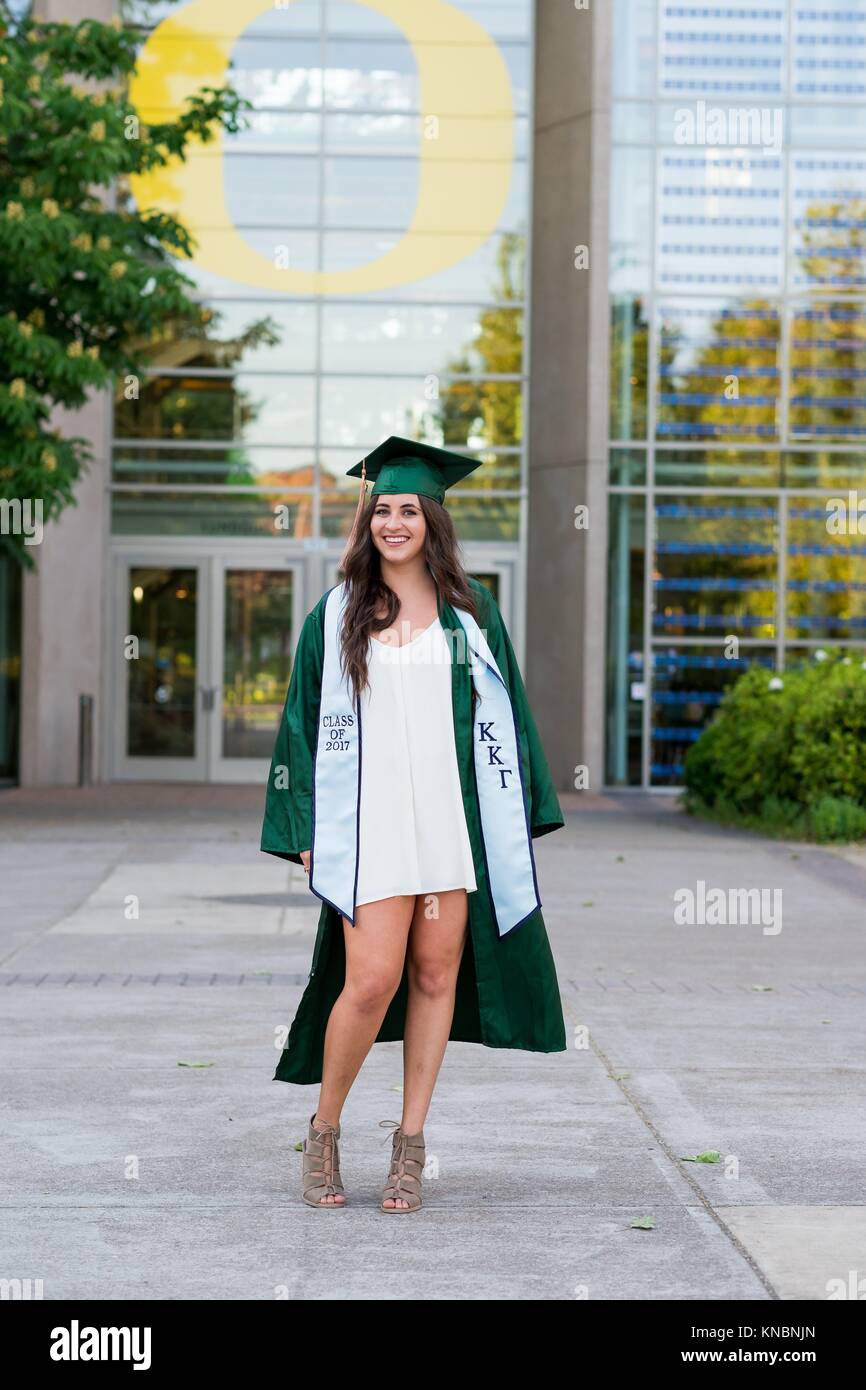 EUGENE, OR - MAY 23, 2017: Female college student posing for graduation photos in the Lillis Business Plaza on campus at the University of Oregon in Stock Photo