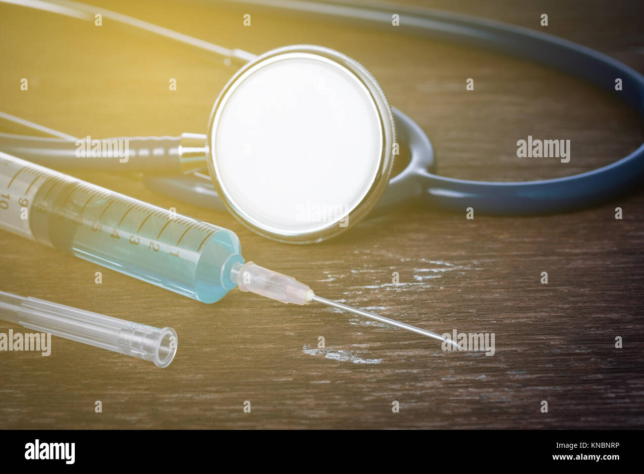 Medical concept , Stethoscope with syringe on wood table Stock Photo ...
