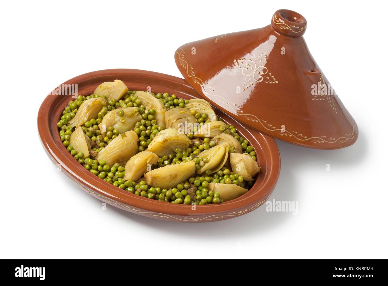 Traditional Moroccan oval tagine with meat, peas and fennel on white