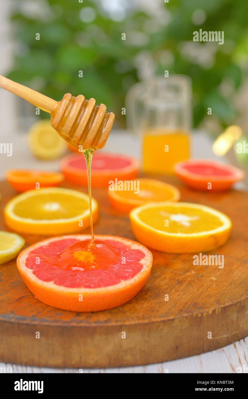 Slices of grapefruit, clementine, orange and honey Stock Photo Alamy