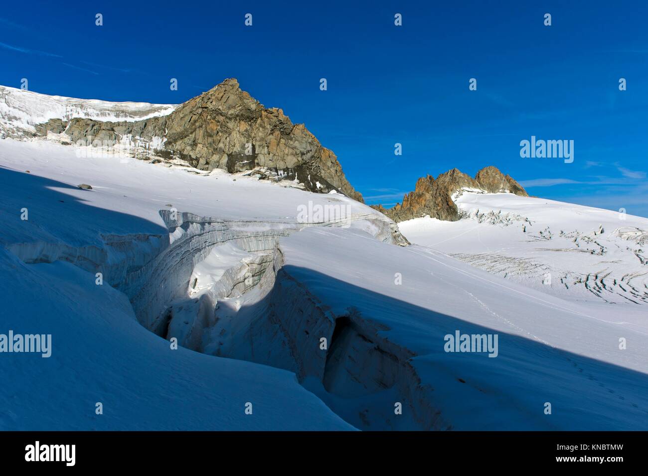 Crevasse on the glacier Plateau du Trient, peaks Tete Blanche and Aiguille du Tour behind, Valais, Switzerland. Stock Photo
