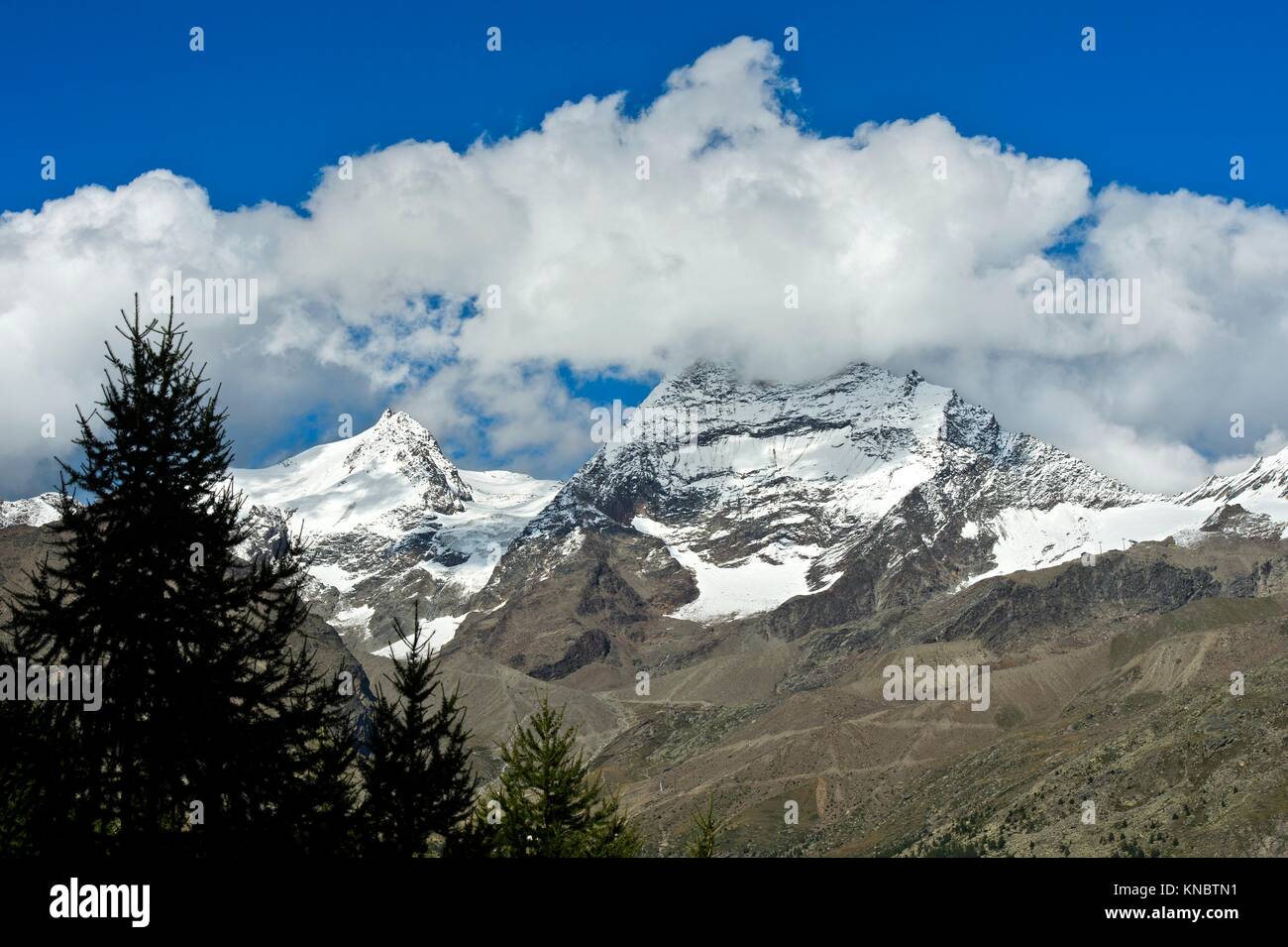 Peaks Fletschhorn and Lagginhorn in the clouds, Saas-Fee, Valais, Switzerland. Stock Photo