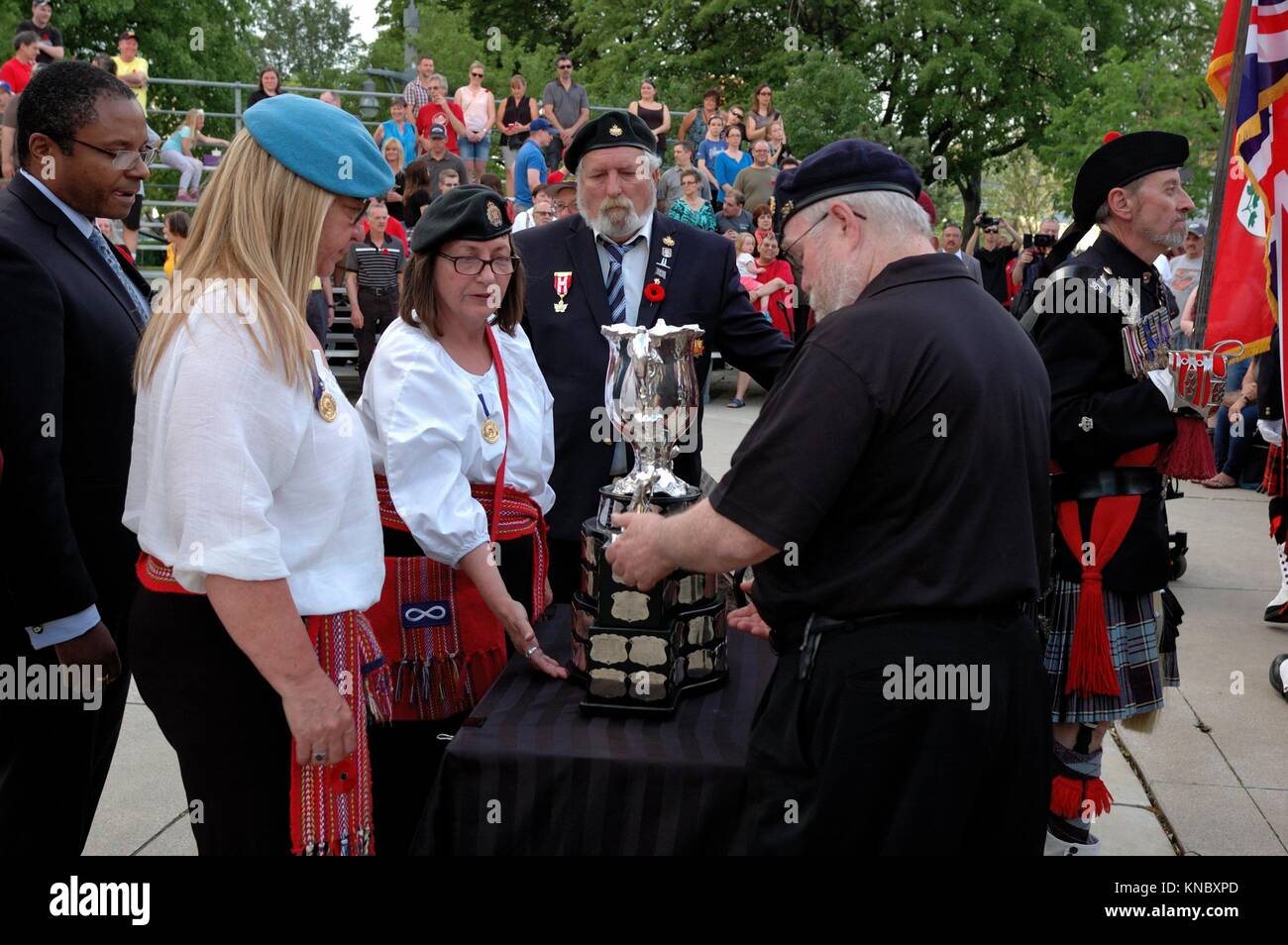 A group of military men and women lift the Memorial Cup and prepare to take it inside Windsor City Hall. The outdoor remembrance ceremony is part of Stock Photo