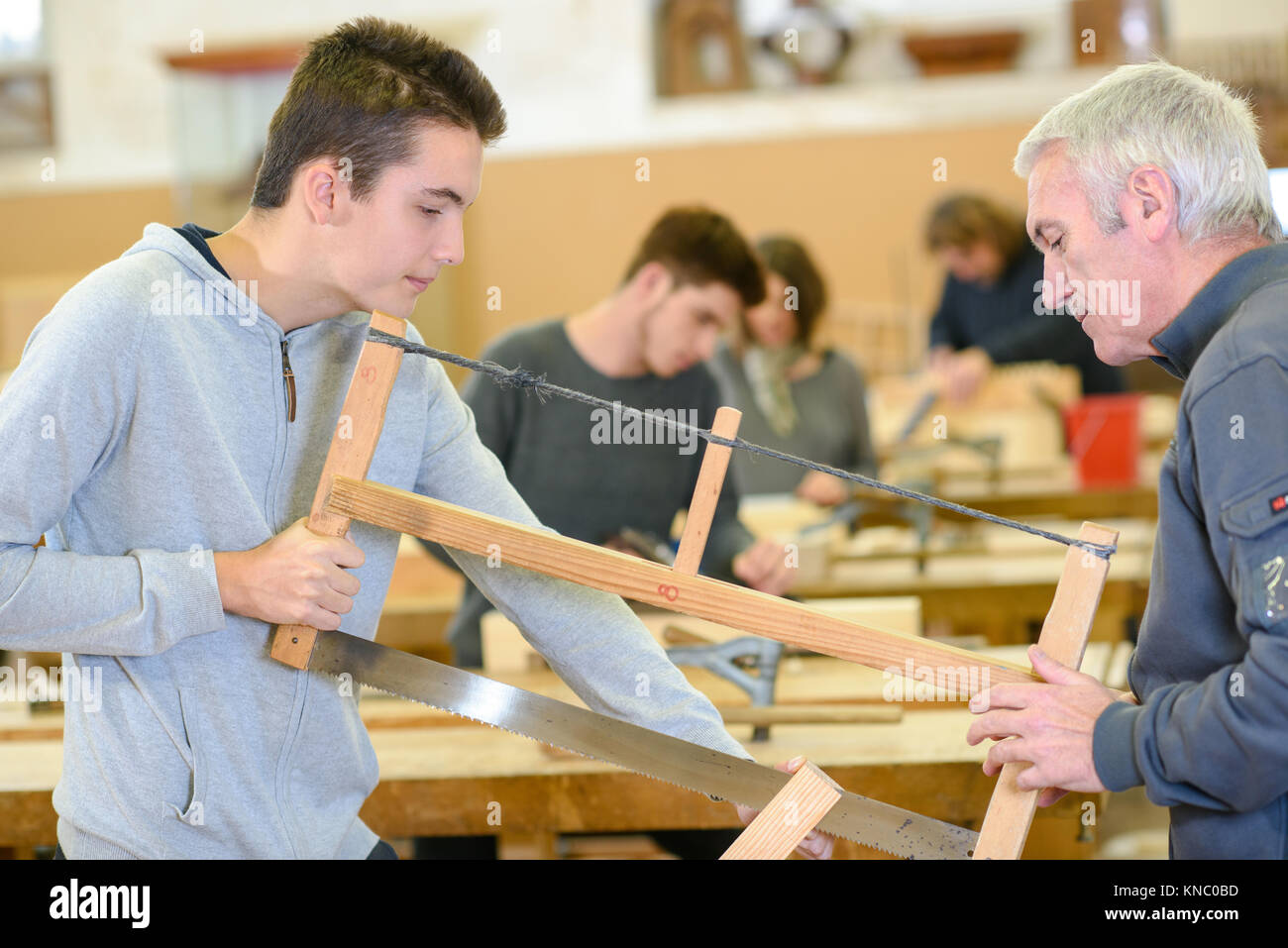 carpenter with apprentice in training period Stock Photo - Alamy
