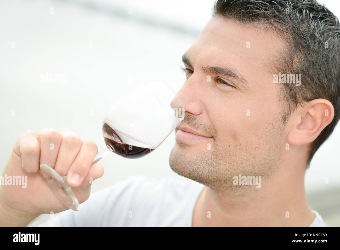 Man tasting some red wine Stock Photo - Alamy