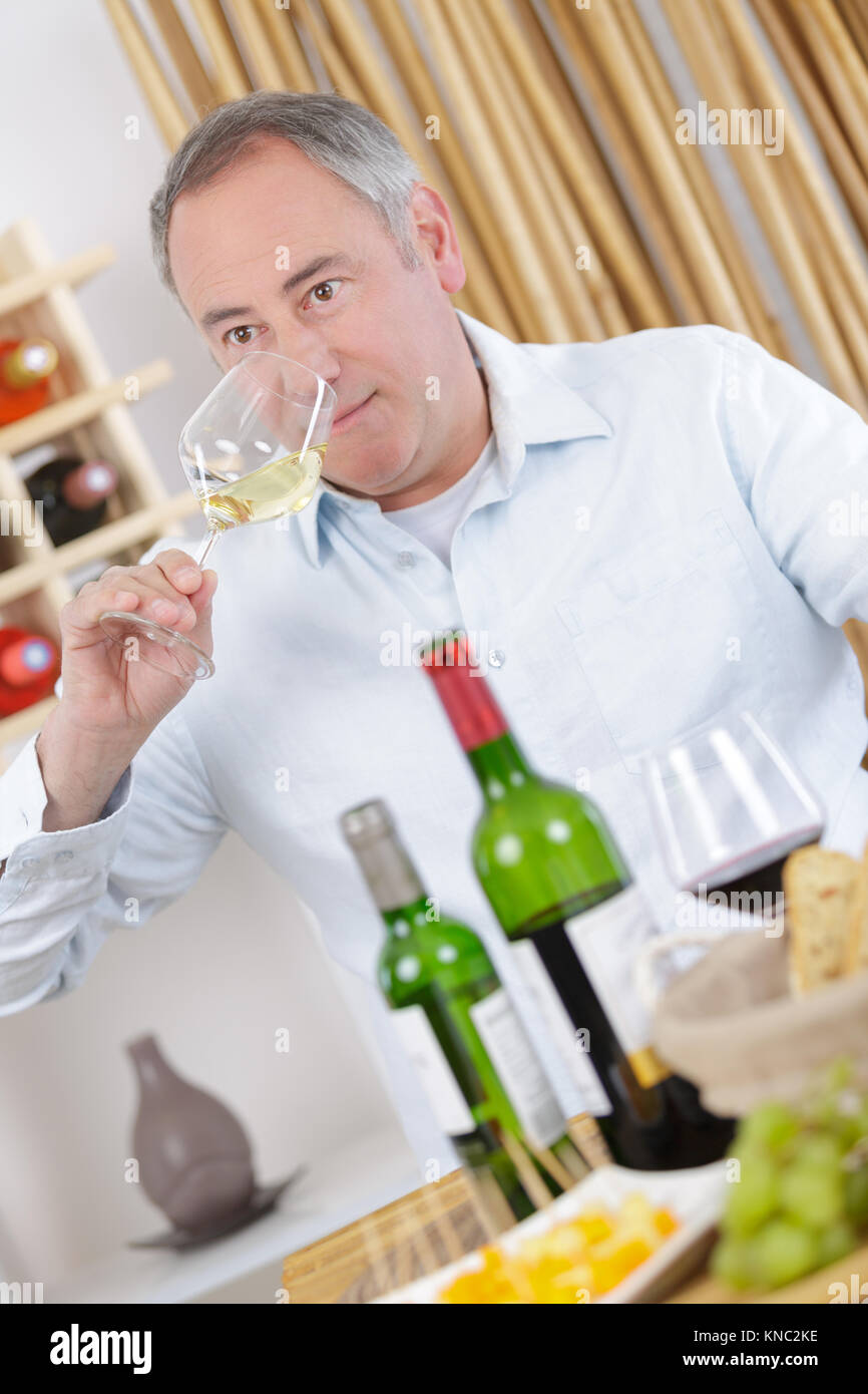 mature man tasting white wine Stock Photo - Alamy