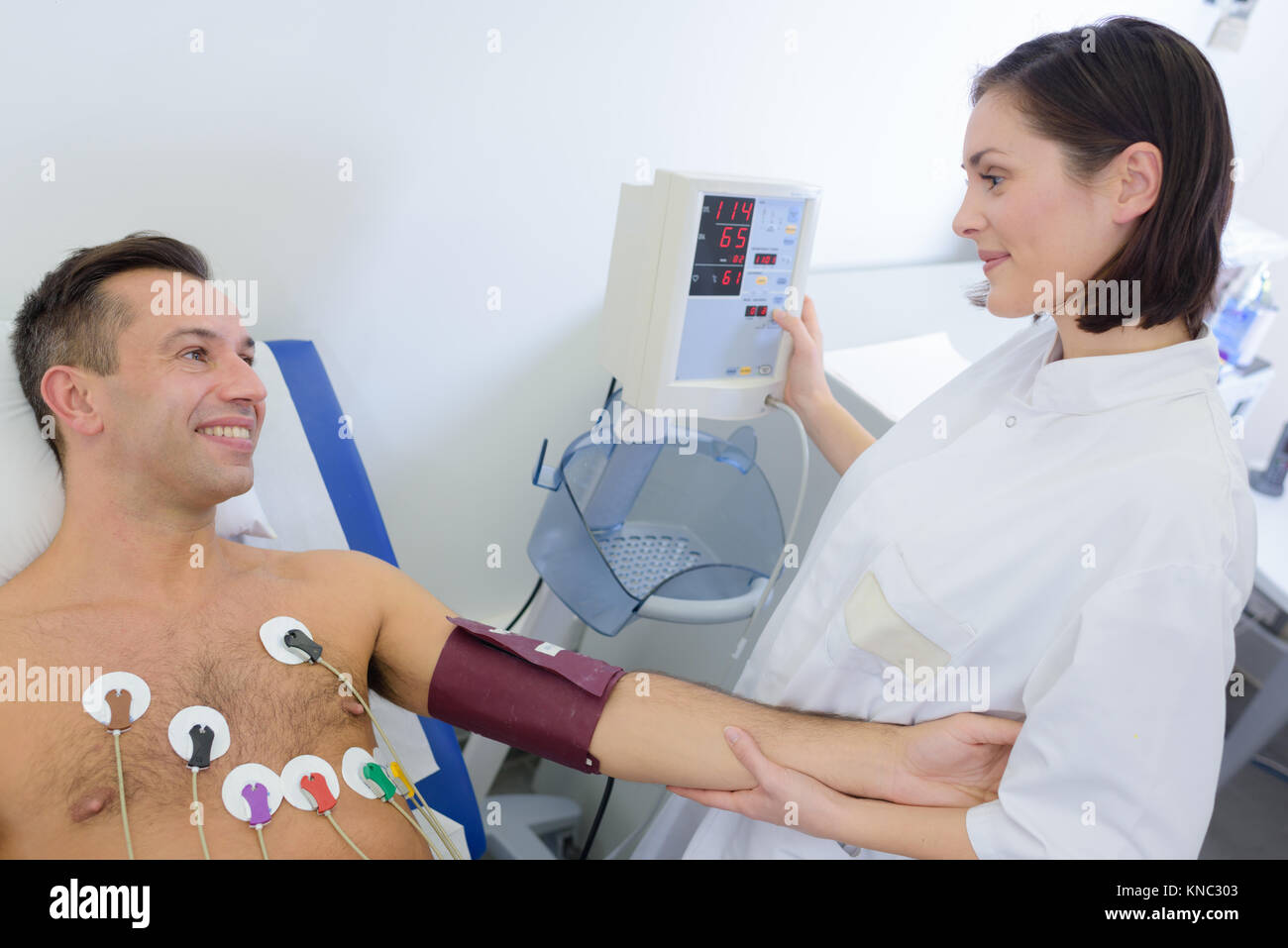 Nurse taking blood pressure of cardiac patient Stock Photo