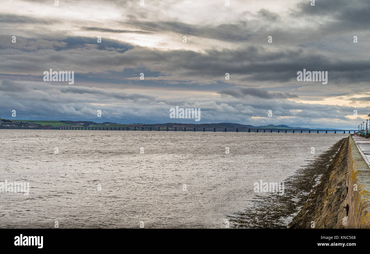 Looking Across the River Tay Dundee Towards the Rail Bridge in the Distance.dark Brooding skys on a December winters day at the Dundee Waterfront. Stock Photo