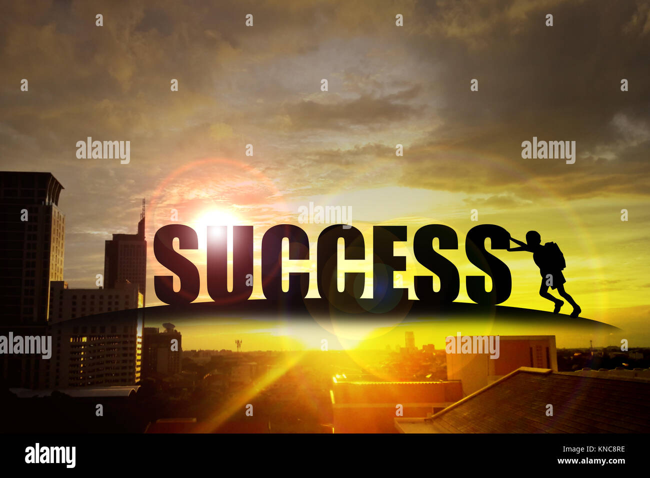 Silhouette of kid pushing the alphabet 'success' on the building at sunset Stock Photo