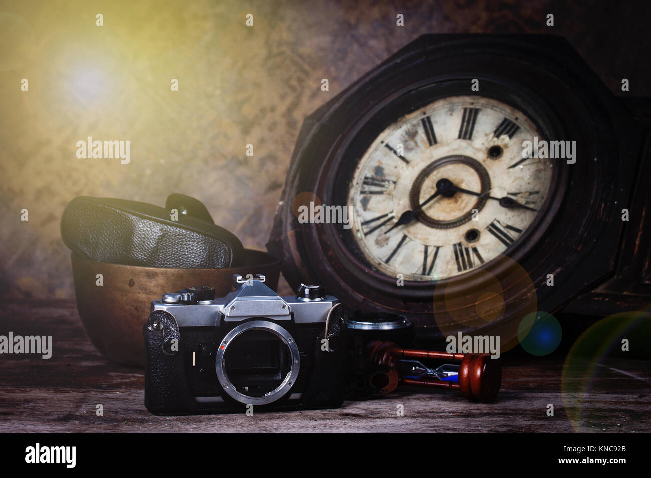 Group of objects on wood table. antique wooden clock, hourglass, old camera ,Still life Stock Photo