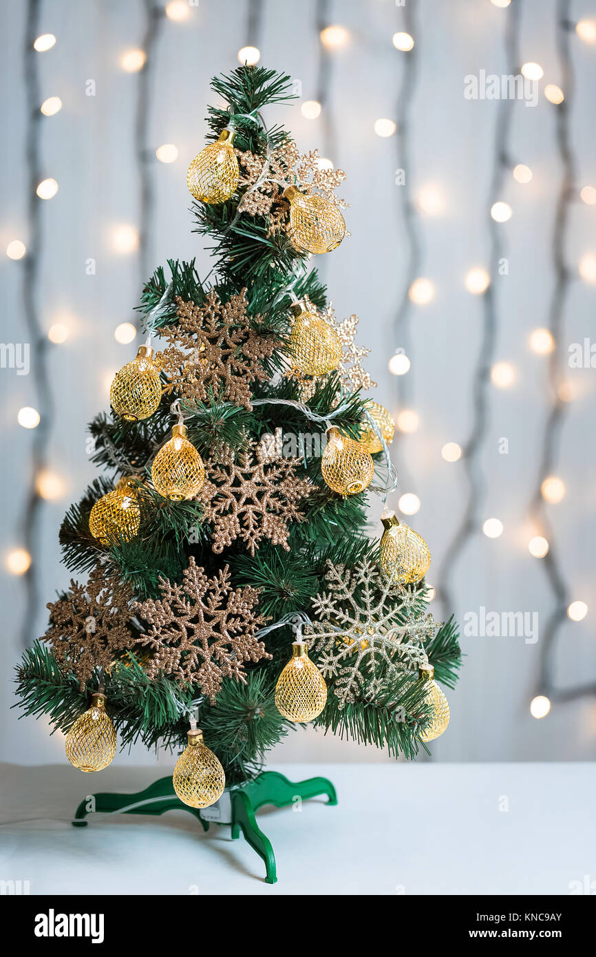 A Christmas tree decorated with snowflakes and a garland on the ...