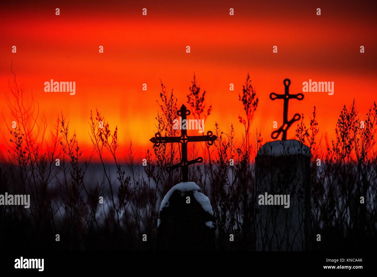 Christian cross silhouette with the bloody sunset as background. Stock Photo
