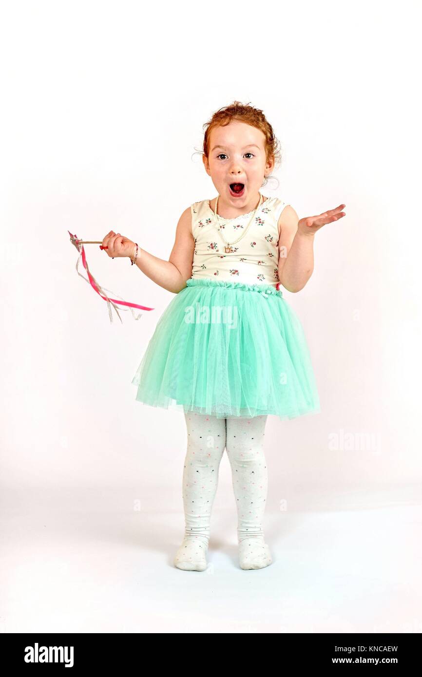 Fashion little girl in green dress, in catwalk model pose, stock photo