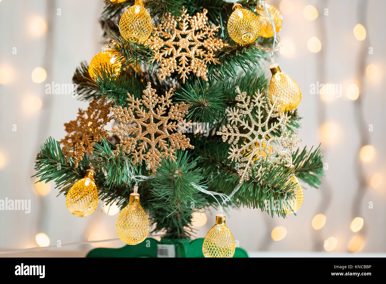 A Christmas tree decorated with snowflakes and a garland on the ...