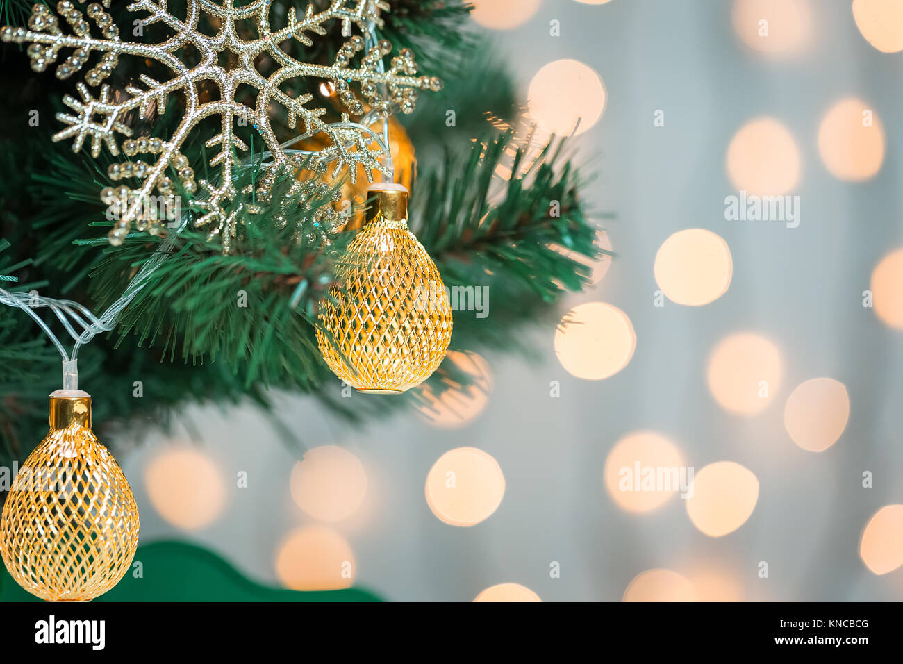 A Christmas tree decorated with snowflakes and a garland on the ...