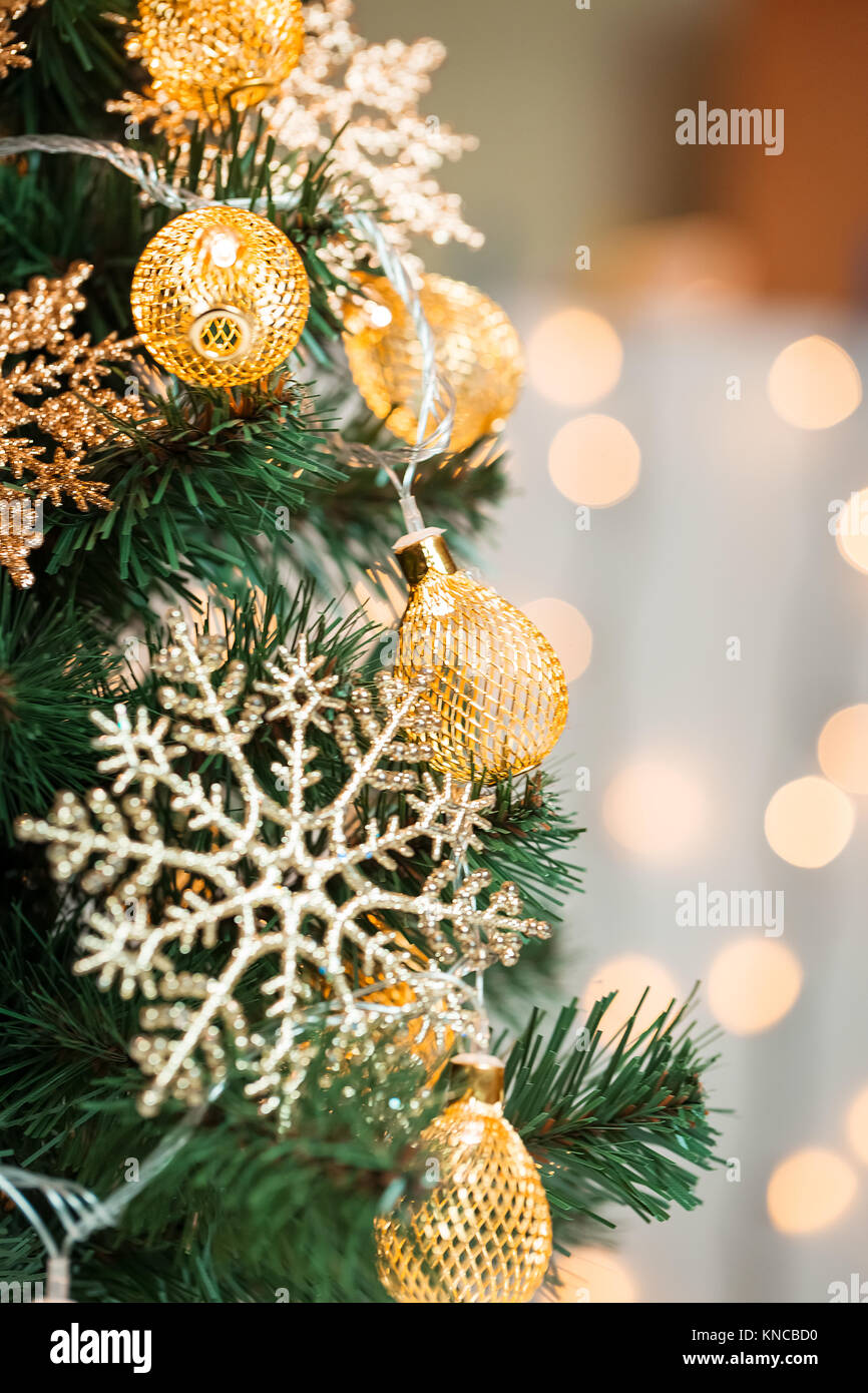 A Christmas tree decorated with snowflakes and a garland on the ...
