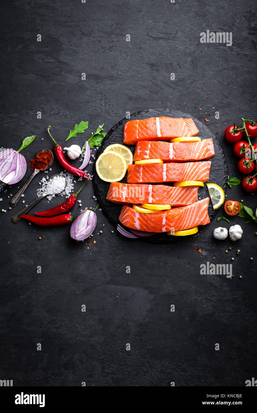 Fresh raw salmon red fish fillet on black background. Top view Stock ...