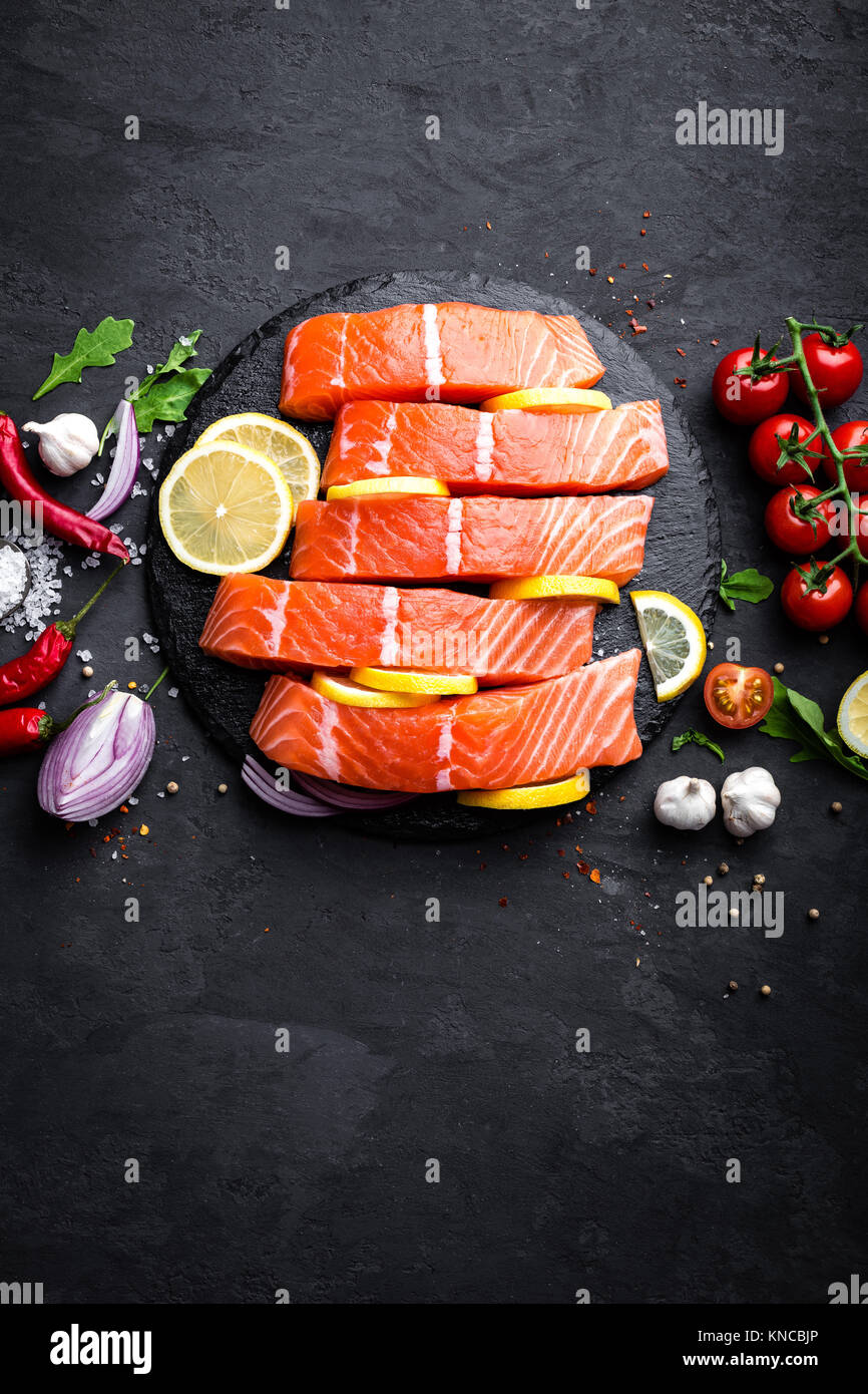 Fresh raw salmon red fish fillet on black background. Top view Stock ...