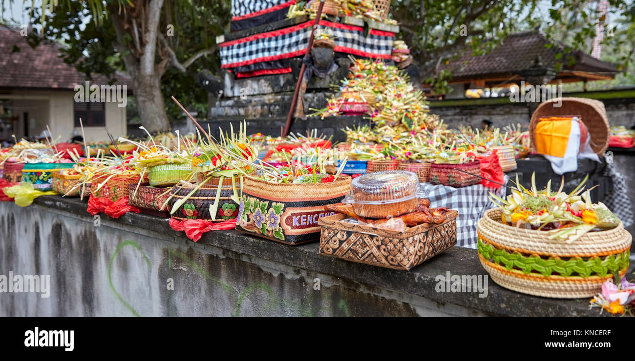 Open-air altar with various food offerings at local temple. Sengkidu village near Candidasa, Karangasem Regency, Bali, Indonesia. Stock Photo