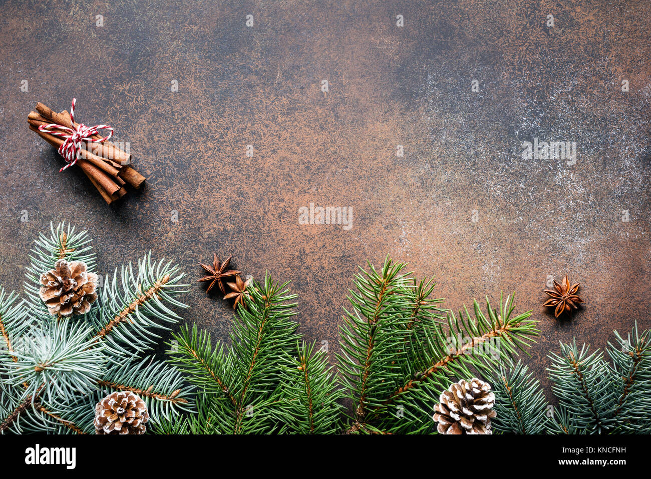 Christmas or New Year background frame composition with fir tree branches, pine cones and spices. Top view, copy space Stock Photo