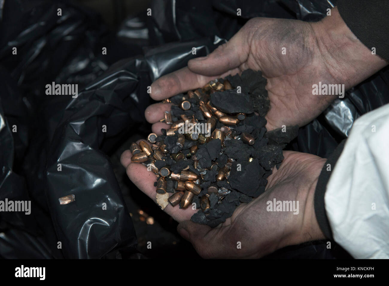 A contractor shows the bullets and rubber that he cleaned in the Training Support Center Benelux 25-meter indoor firing range, on Chièvres Air Base, Belgium, Dec. 6, 2017. In accordance with the U.S. Army and U.S. Army Europe Sustainable Range Program, the TSC Benelux 25-meter indoor firing range is regularly maintained, bullets are removed from the bullet catcher, and all lead, contaminated debris and hazardous material are safely disposed. (U.S. Army Stock Photo