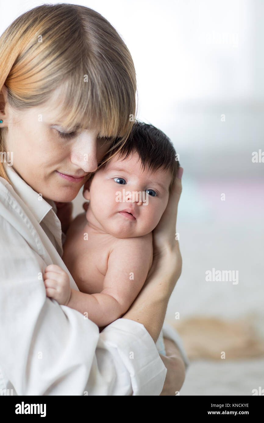 Mother hugging baby Stock Photo