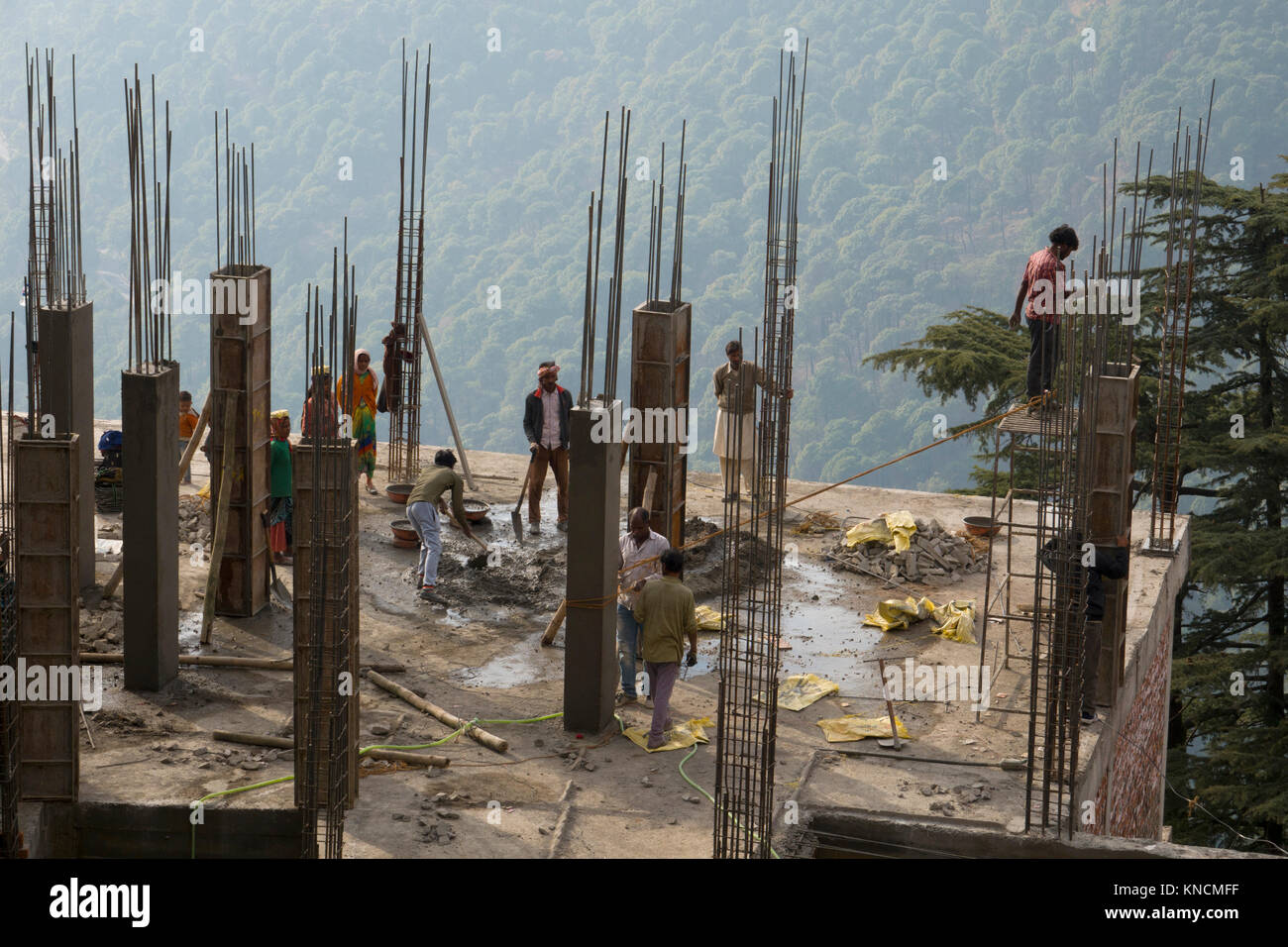 Indian construction workers building a concrete building in Mcleod Ganj, India Stock Photo