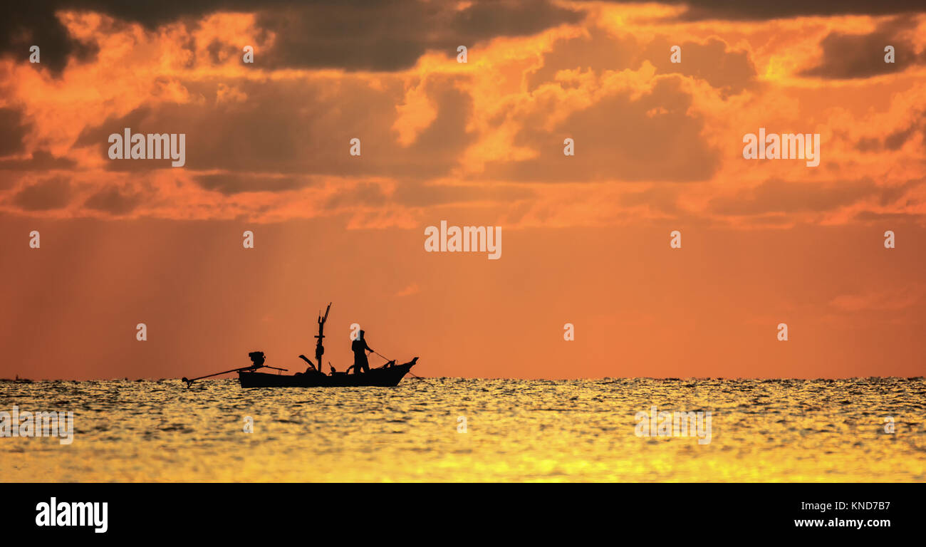 Silhouette of fishing boat and fisher man on sea in the morning Stock ...