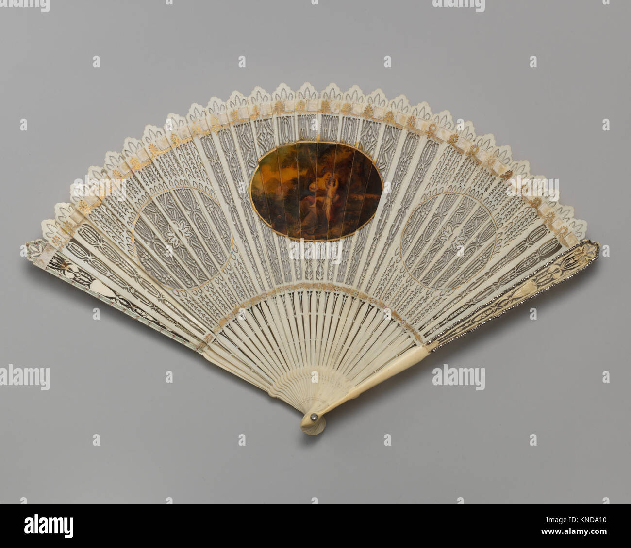 This decorative handheld fan features intricate design, representing artistic craftsmanship and elegance of its historical period. Stock Photo