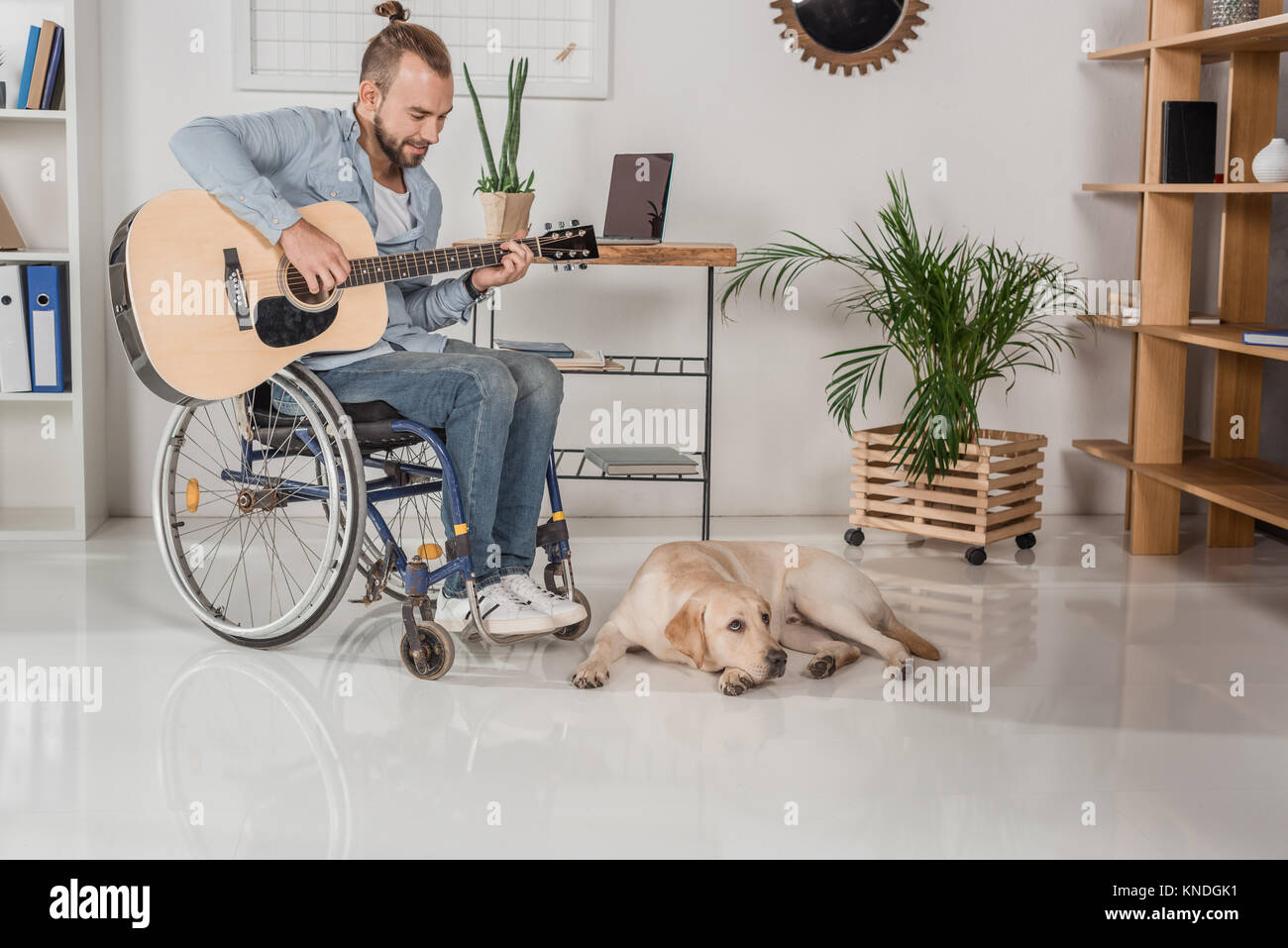 man on wheelchair playing guitar Stock Photo