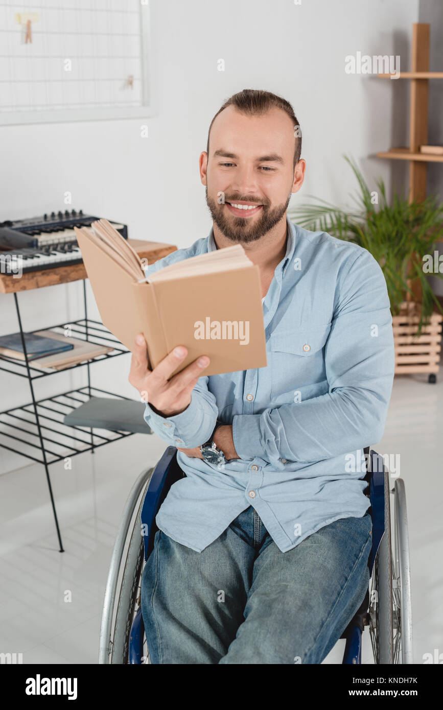 man on wheelchair reading book Stock Photo Alamy