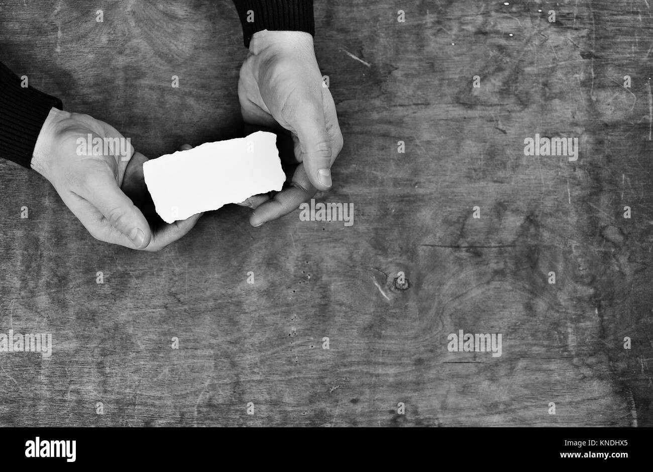 monochrome photo male hands holding a white blank sheet of paper Stock ...