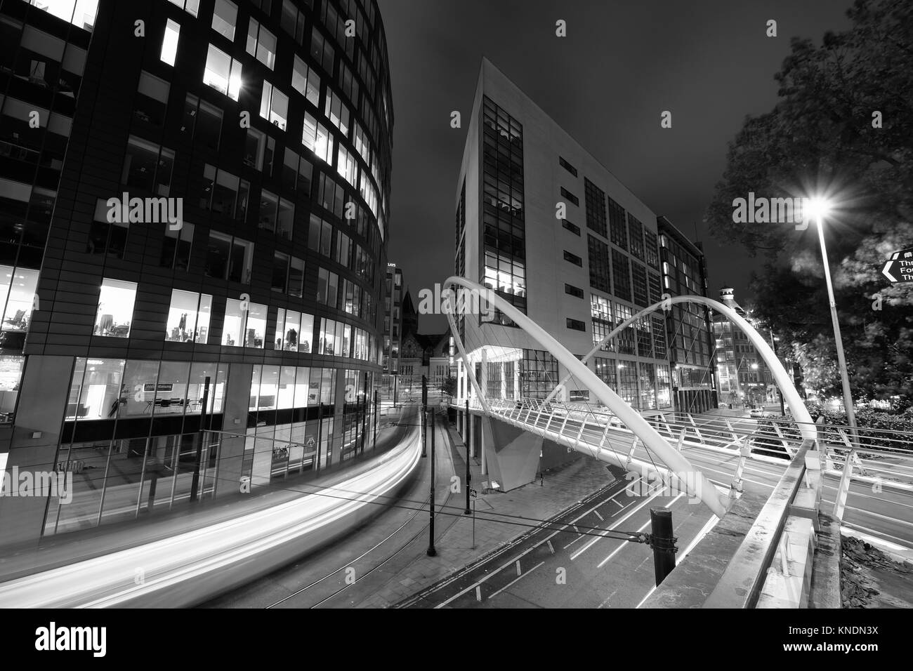 Manchester city centre at night with trams in motion Stock Photo Alamy