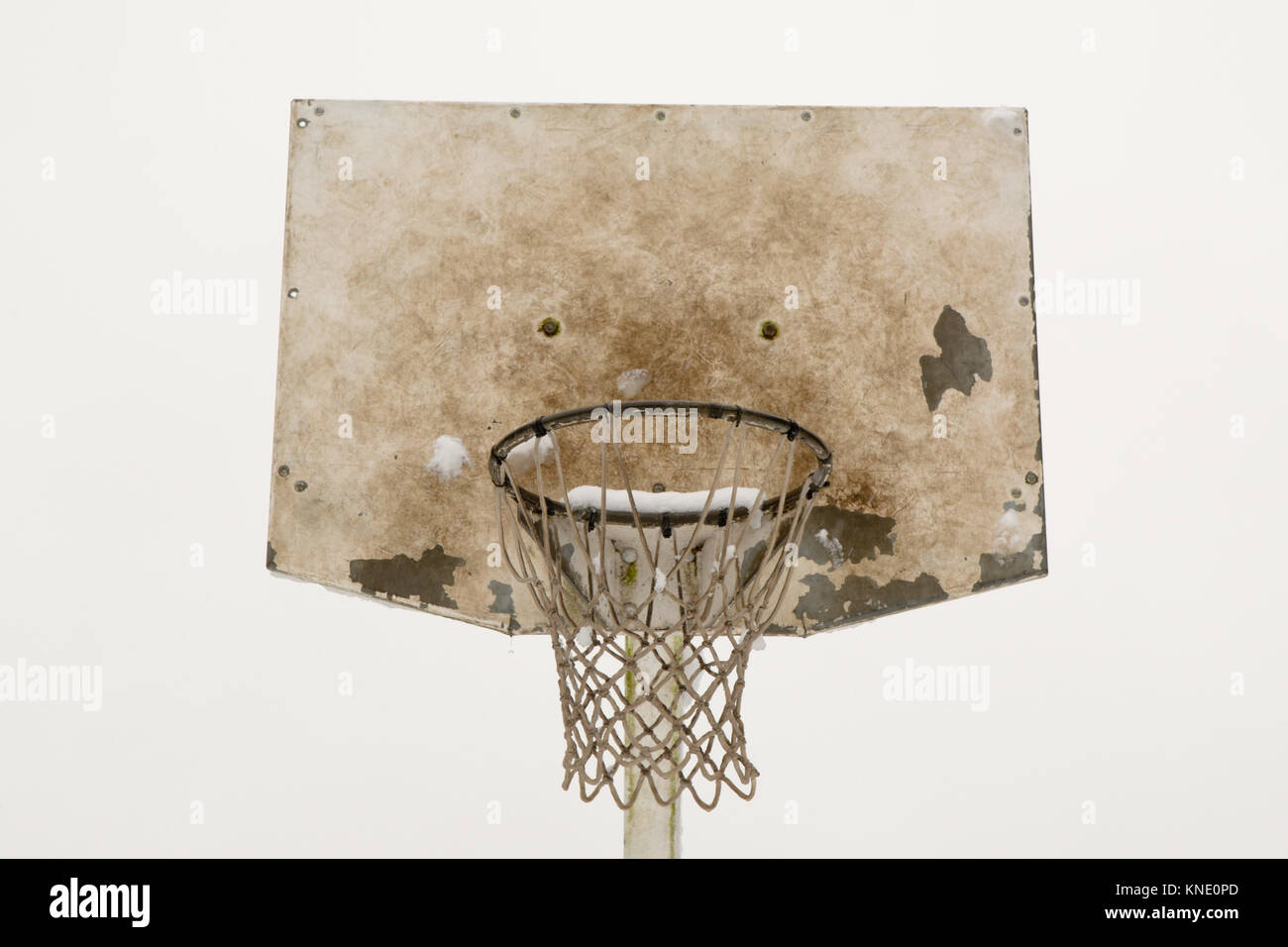 Outdoor basketball net and backboard covered in snow in winter Stock